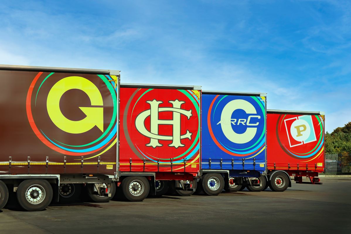 Four Gregory Group brands represented by trailers.