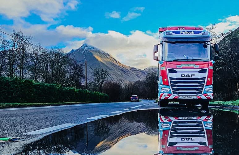 Pollock lorry parked up reflection in puddle.
