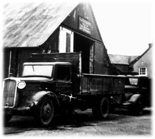 Gregory truck outside shed from 1920s.