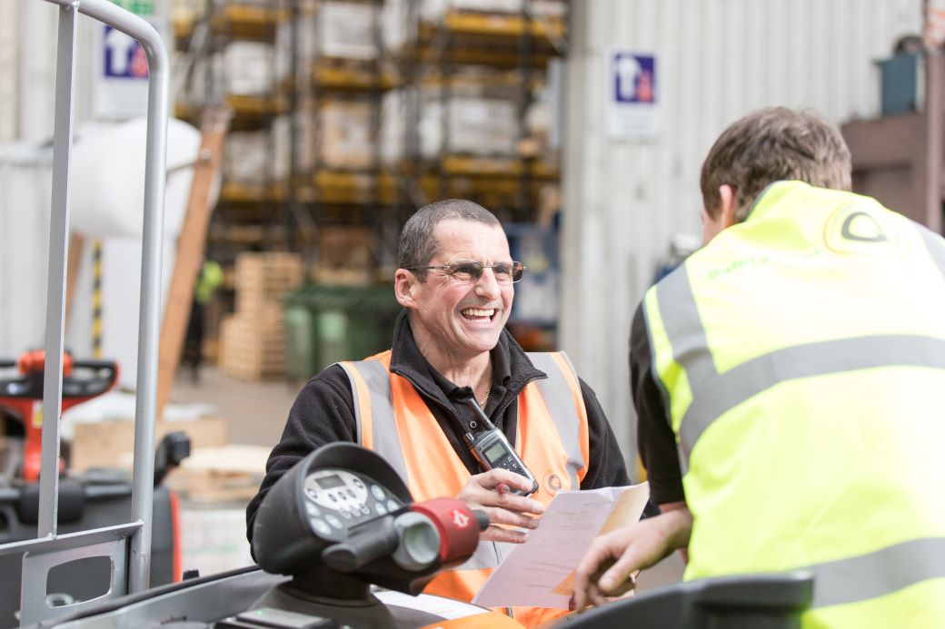 Two employees in Gregory Group warehouse.